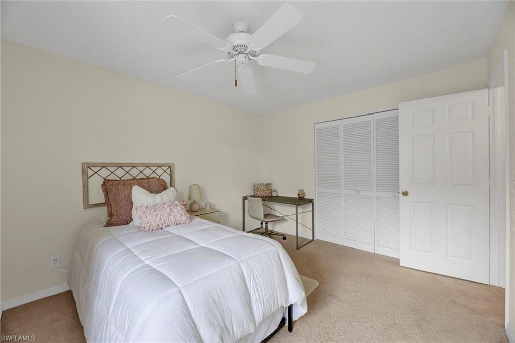 Bedroom with carpet, a closet, and ceiling fan