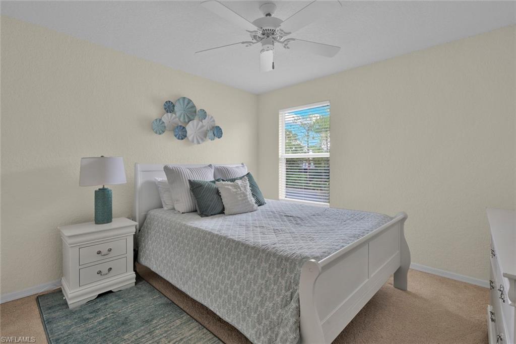 Bedroom featuring light carpet and ceiling fan