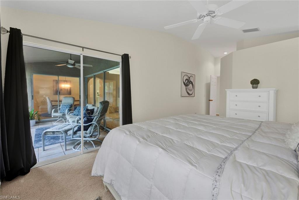 Bedroom with access to exterior, carpet, and a ceiling fan