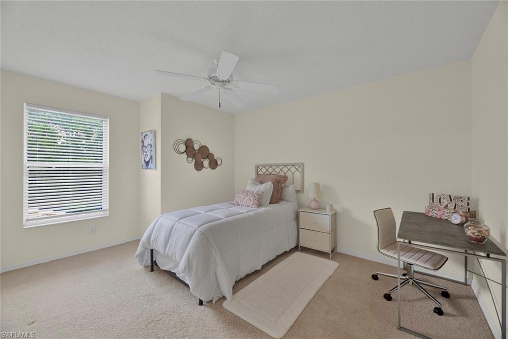 Bedroom featuring carpet flooring, a ceiling fan, and an office area