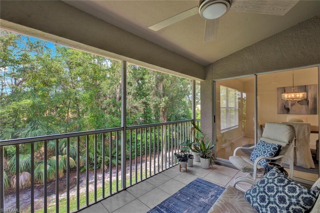 Sunroom with lofted ceiling, ceiling fan, a balcony, and suspended lighting