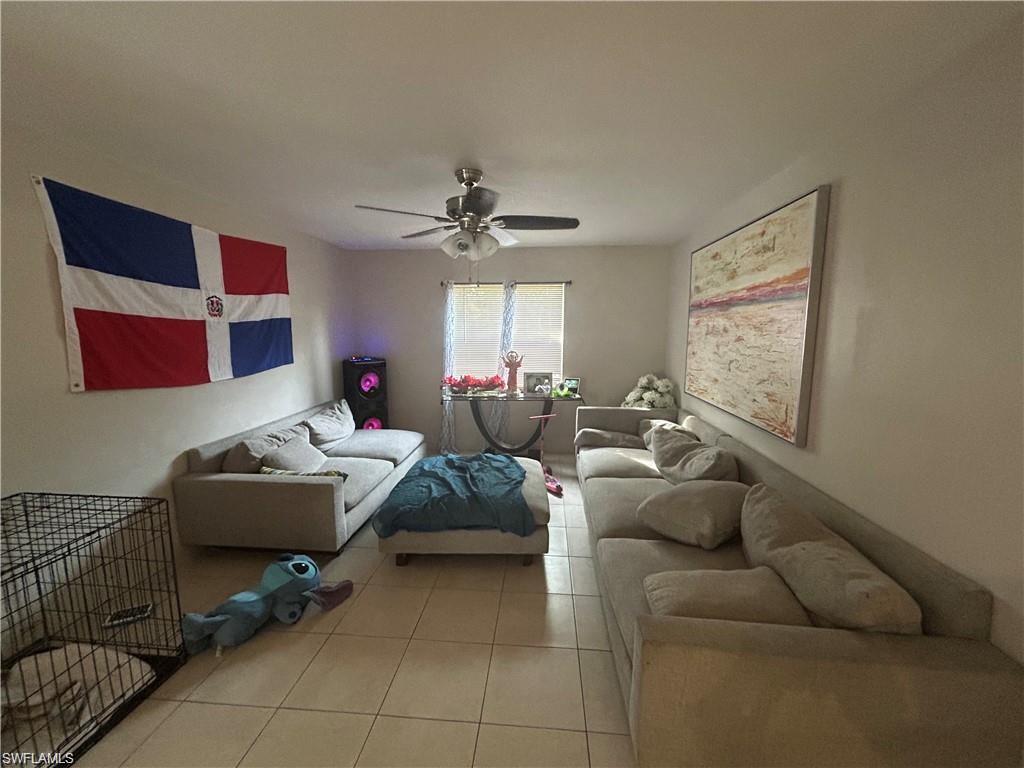 Bedroom featuring a ceiling fan and tile patterned flooring