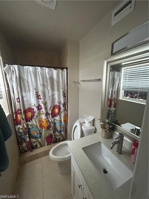 Full bath with vanity, a shower with shower curtain, and light tile patterned floors