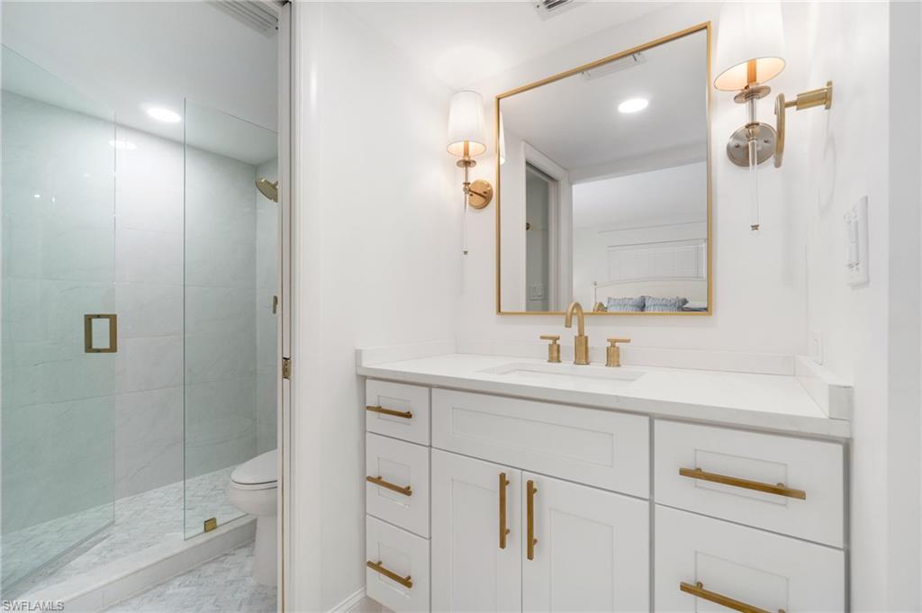 Full bath with vanity, a shower stall, and recessed lighting