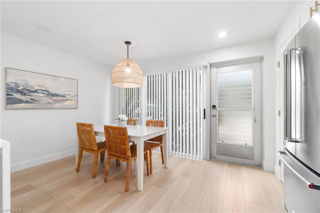 Dining space with light wood-style floors and baseboards
