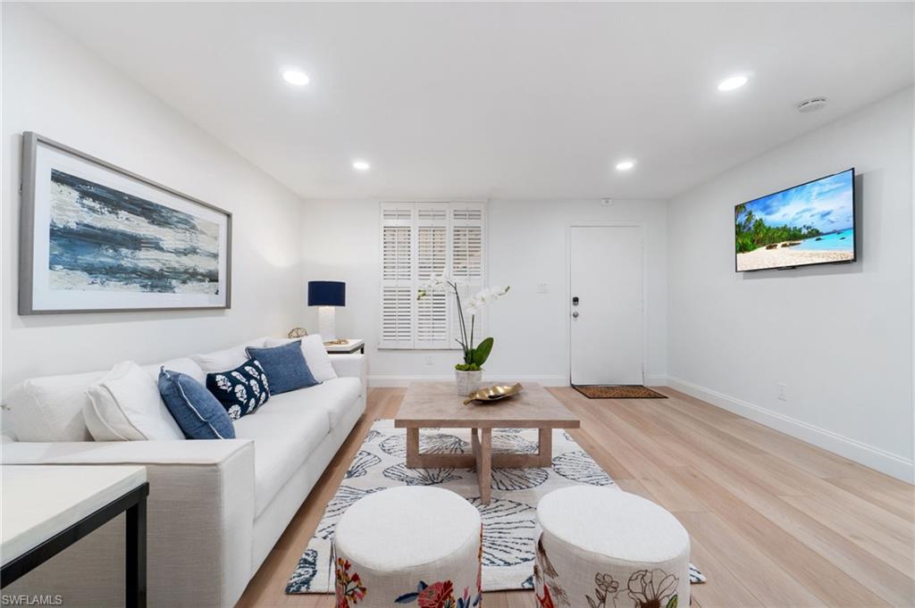 Living area featuring light wood-style flooring and recessed lighting