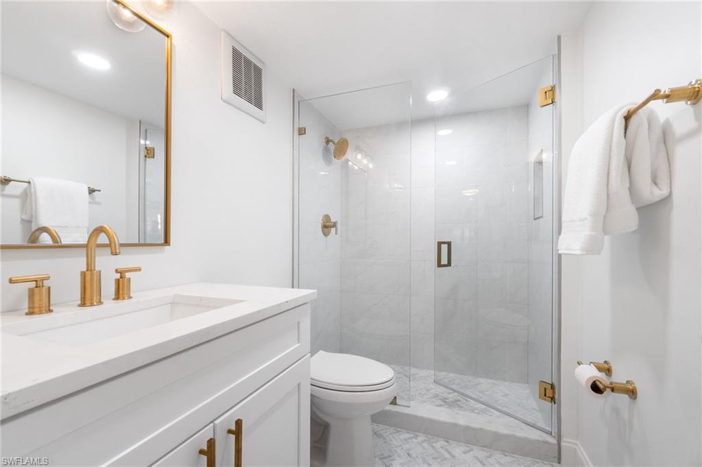 Full bath with vanity and a shower stall