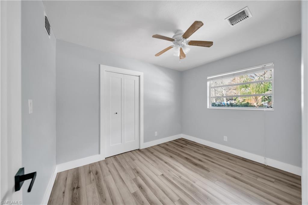 Spare room featuring light wood-type flooring and a ceiling fan
