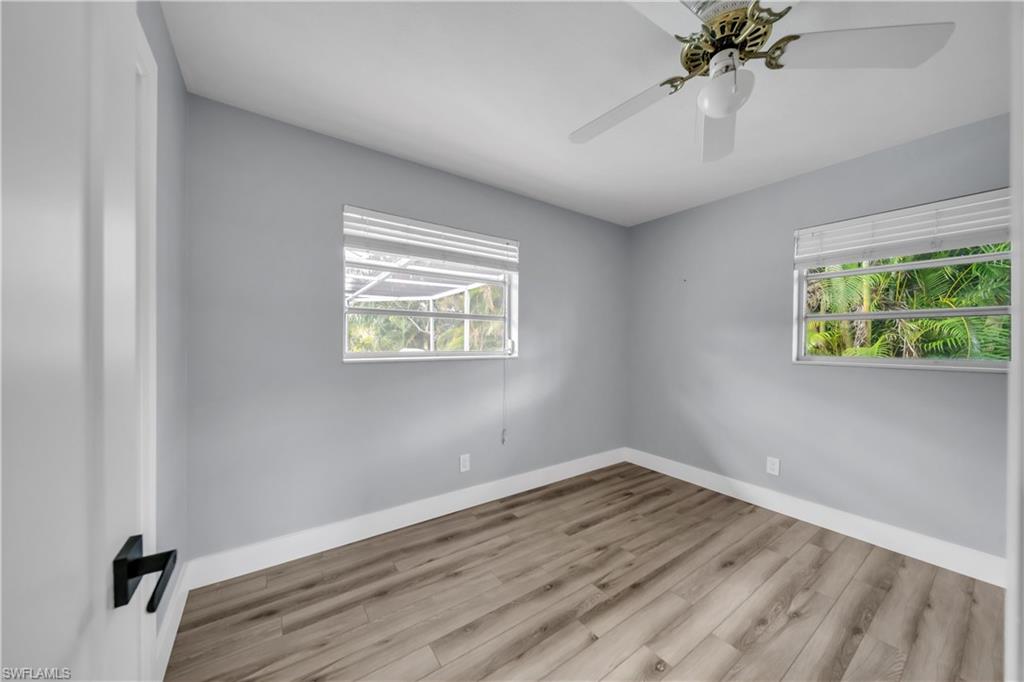 Empty room featuring wood finished floors and a ceiling fan