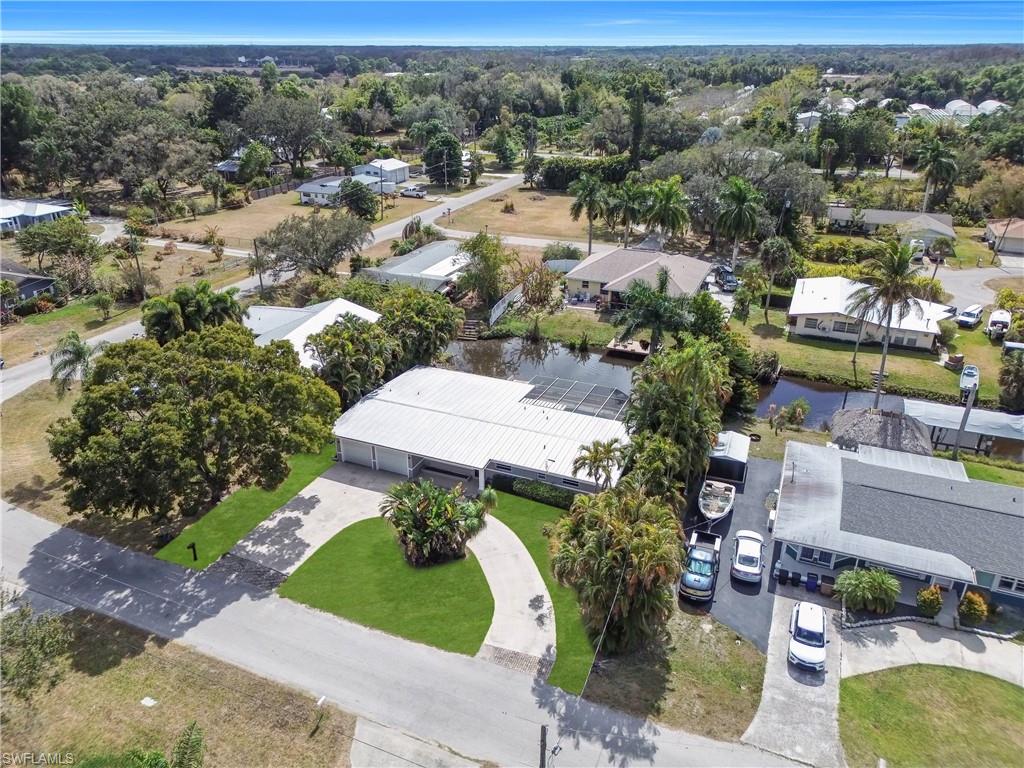 Aerial perspective of suburban area featuring a nearby body of water