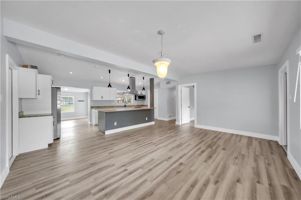 Unfurnished living room featuring light wood-style floors and recessed lighting