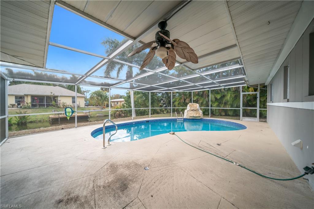 Outdoor pool featuring a sunroom, a lanai, and a patio area