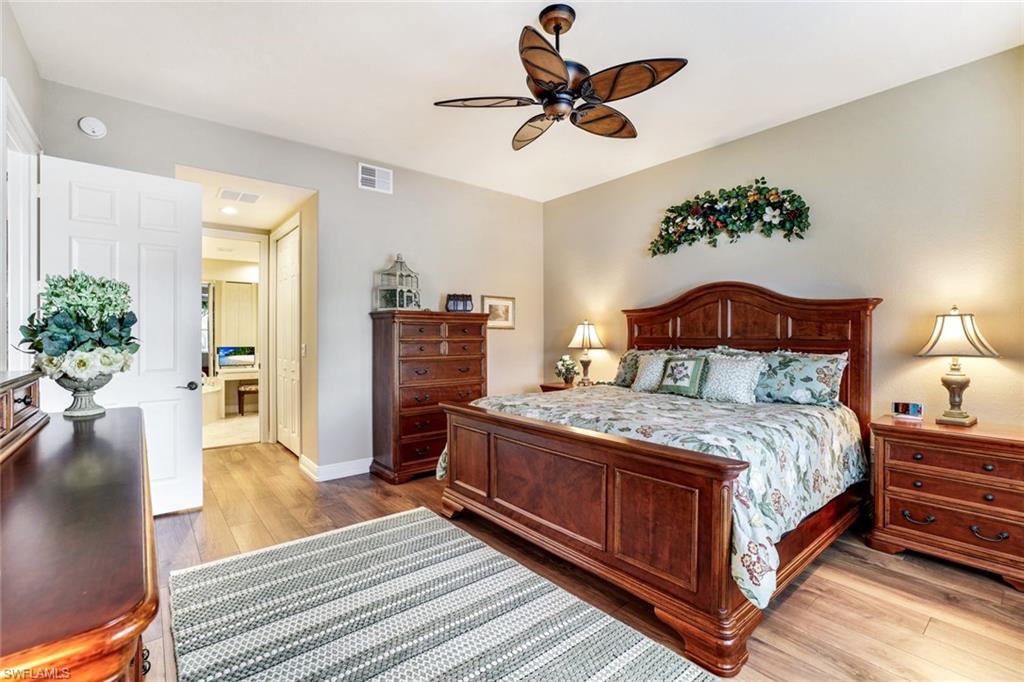 Bedroom with light wood finished floors, a closet, and ceiling fan