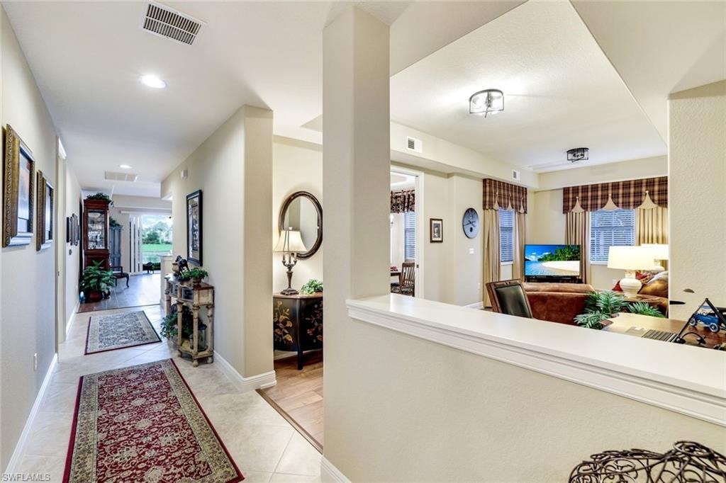 Corridor featuring baseboards and recessed lighting