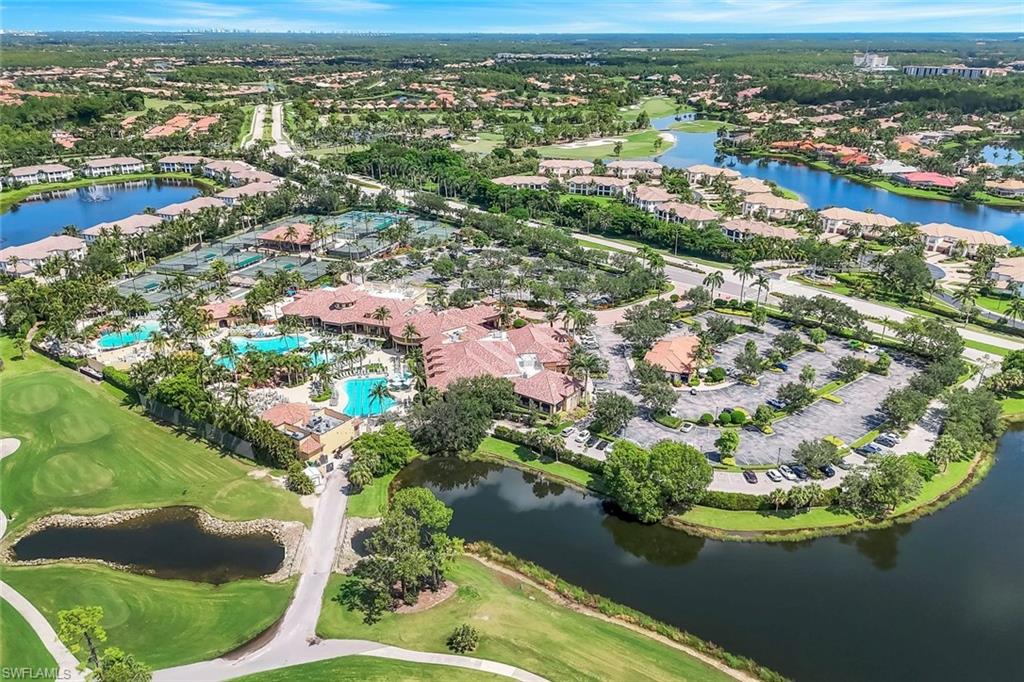 View of property location featuring a nearby body of water, nearby suburban area, and a golf club