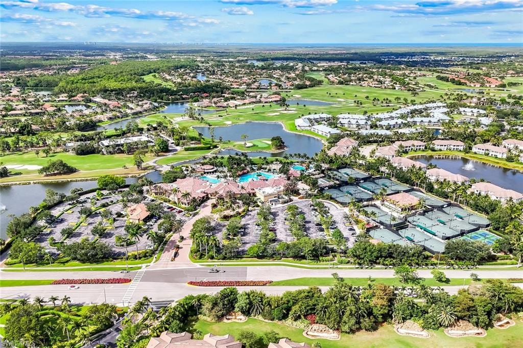 Aerial view of residential area with a golf club and a nearby body of water
