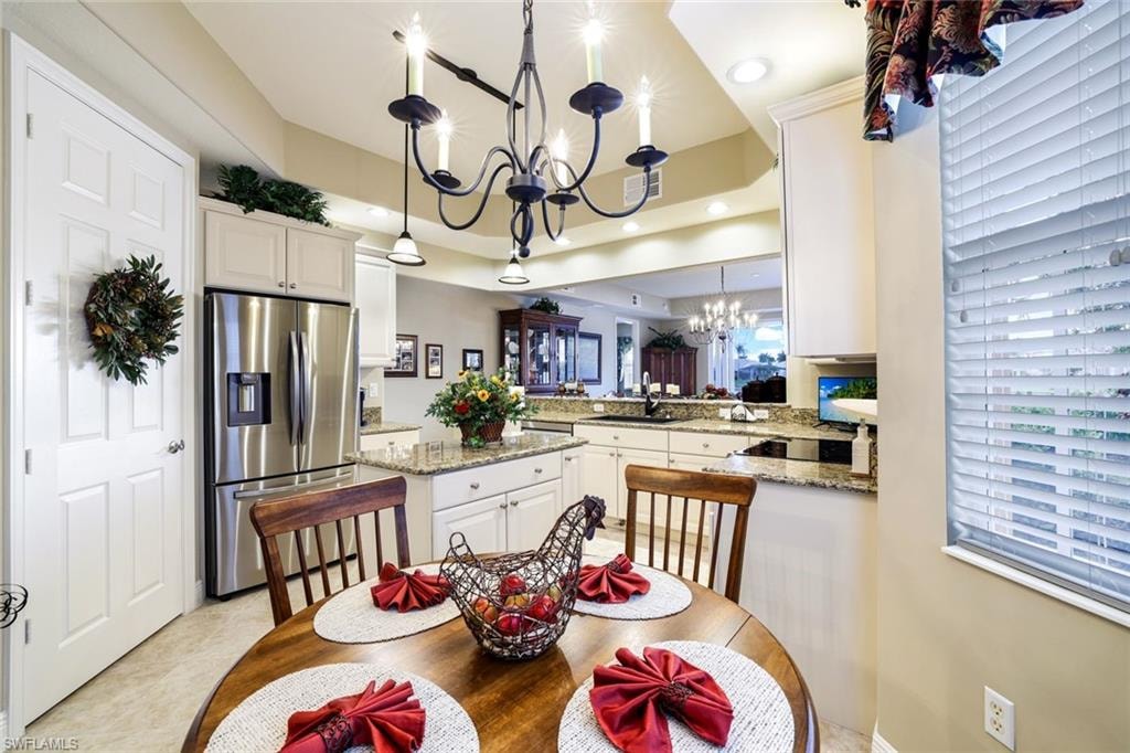 Dining area with hanging lights and a raised ceiling