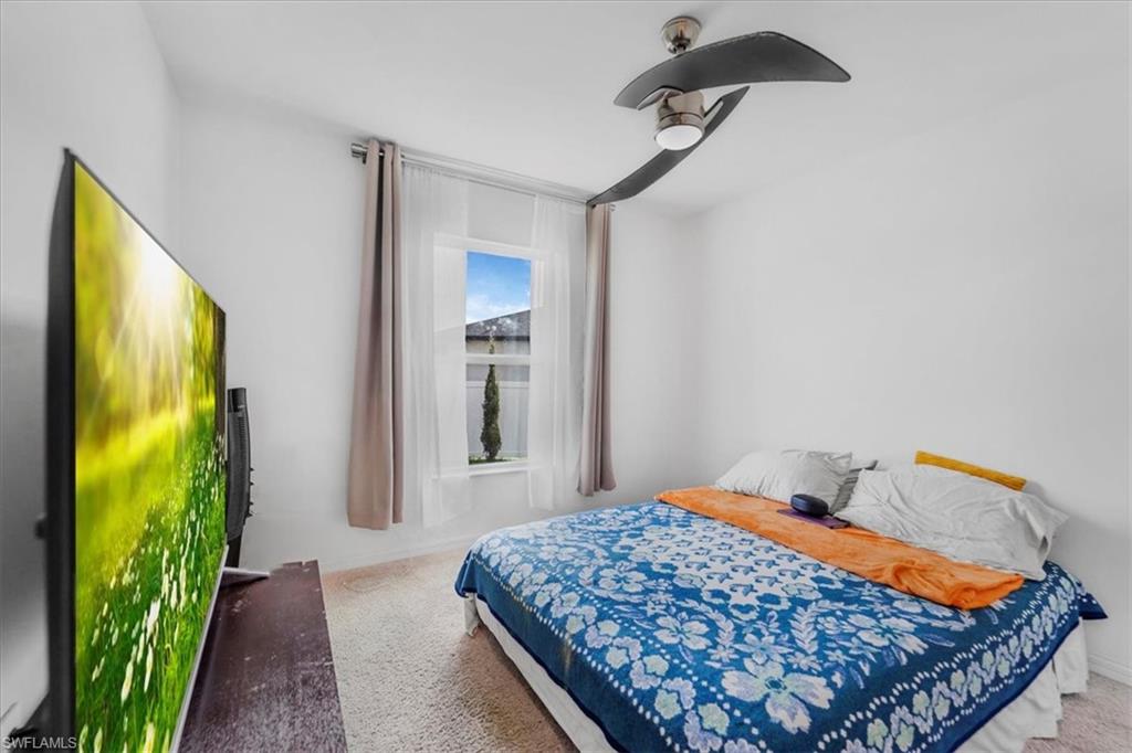 Bedroom with carpet floors and a ceiling fan