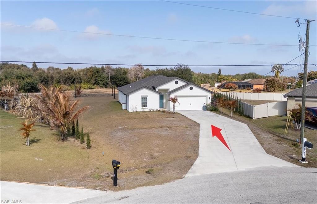 Ranch-style house featuring concrete driveway and a garage