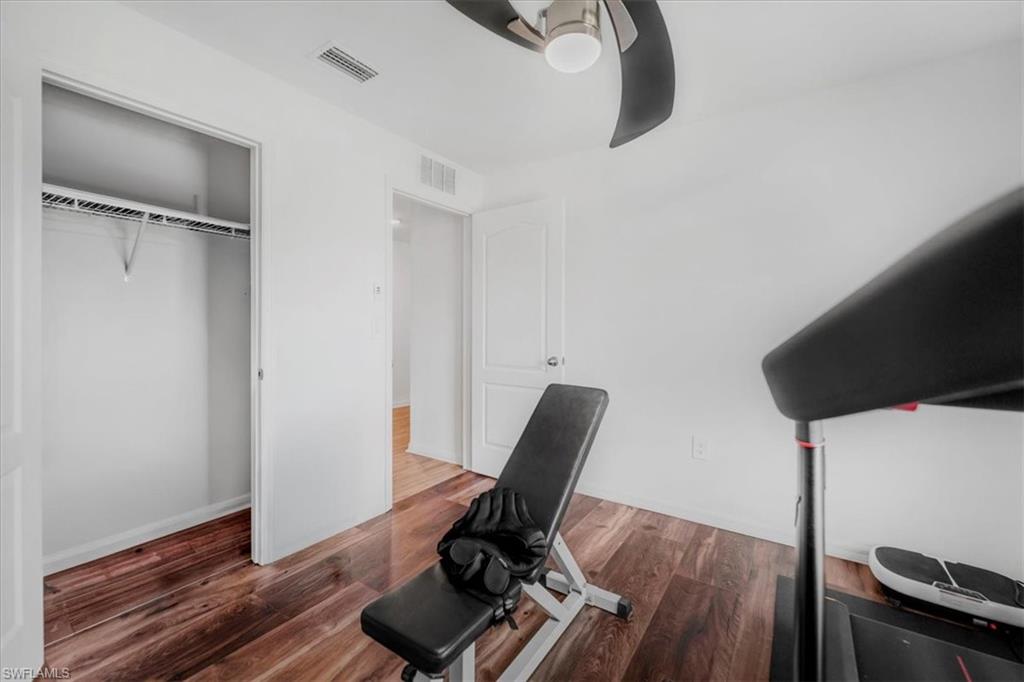 Unfurnished office featuring a ceiling fan and dark wood finished floors