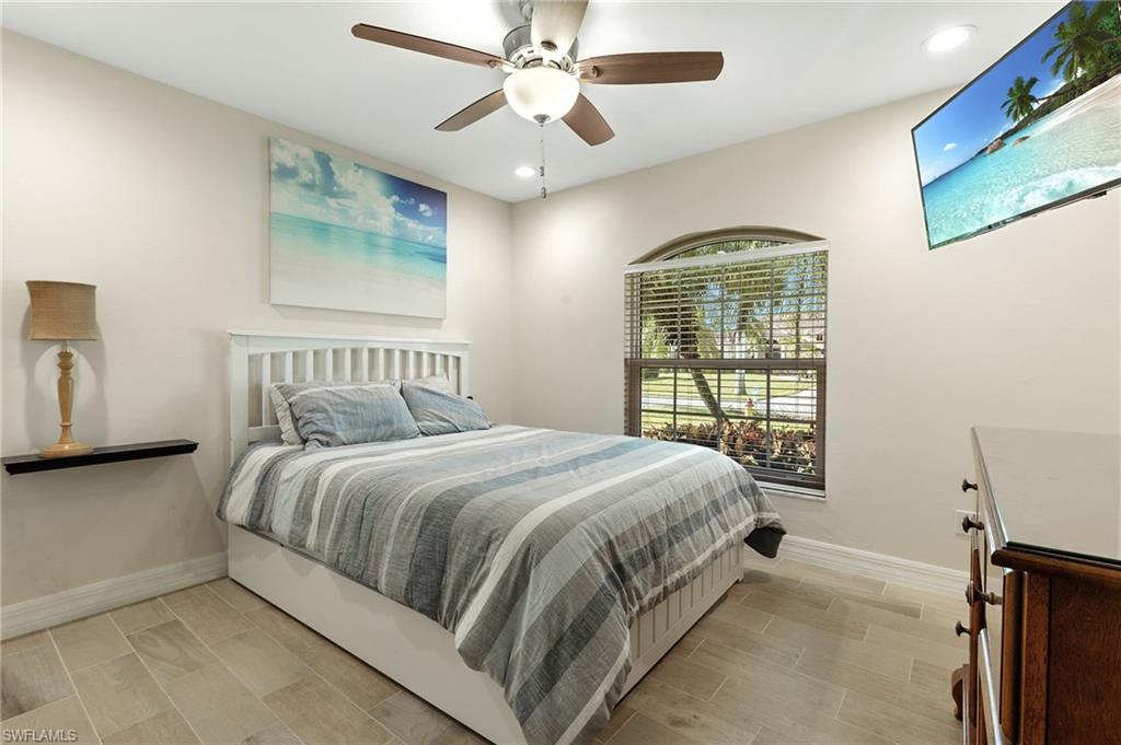 Bedroom featuring wood finish floors, a ceiling fan, and recessed lighting