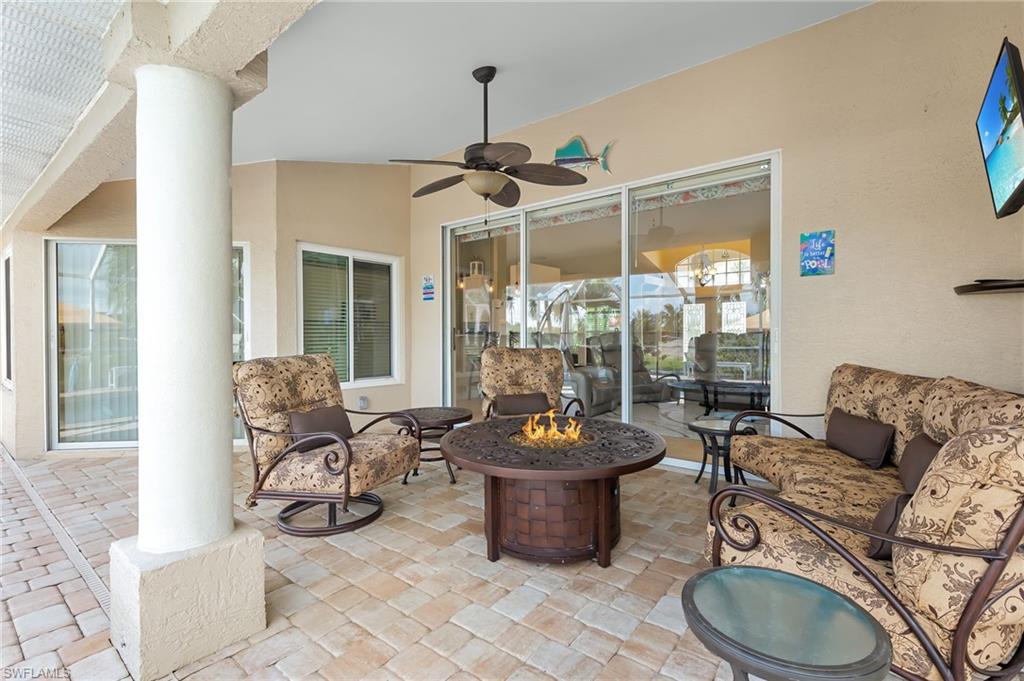 View of patio / terrace featuring a ceiling fan and a fire pit