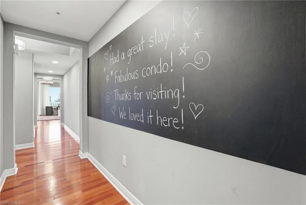 Hallway with half bath and large chaulk board