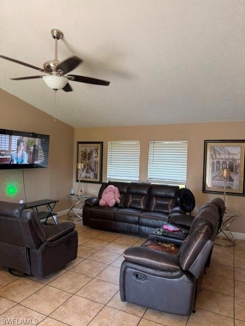 Living area with ceiling fan and light tile patterned floors