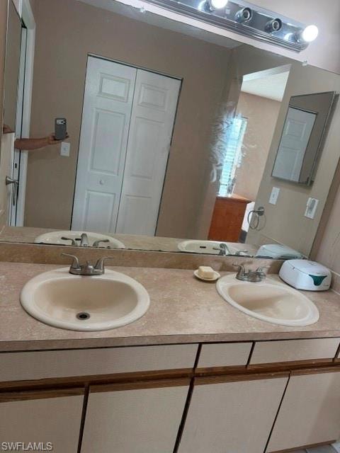 Full bath with double vanity and a closet