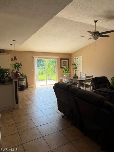 Living area with a ceiling fan and light tile patterned floors