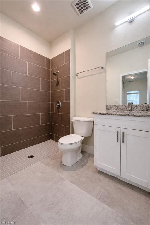 Unfurnished bedroom with a closet and light tile patterned floors