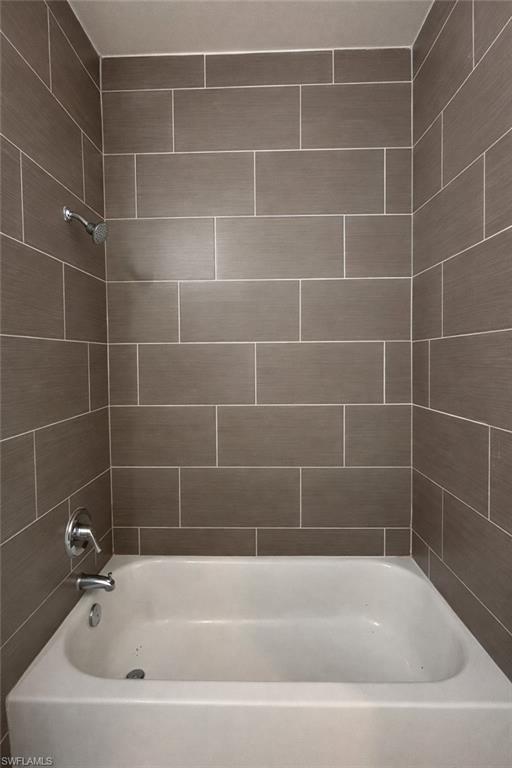 Walk in closet with tile patterned flooring