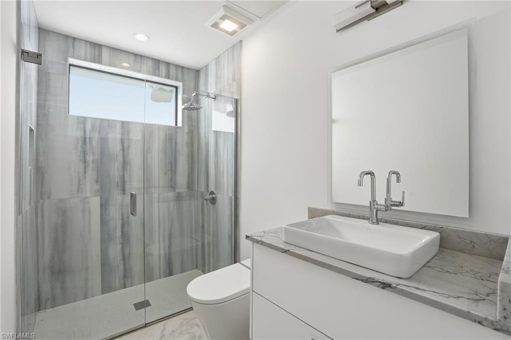 Full bathroom featuring a shower stall and vanity