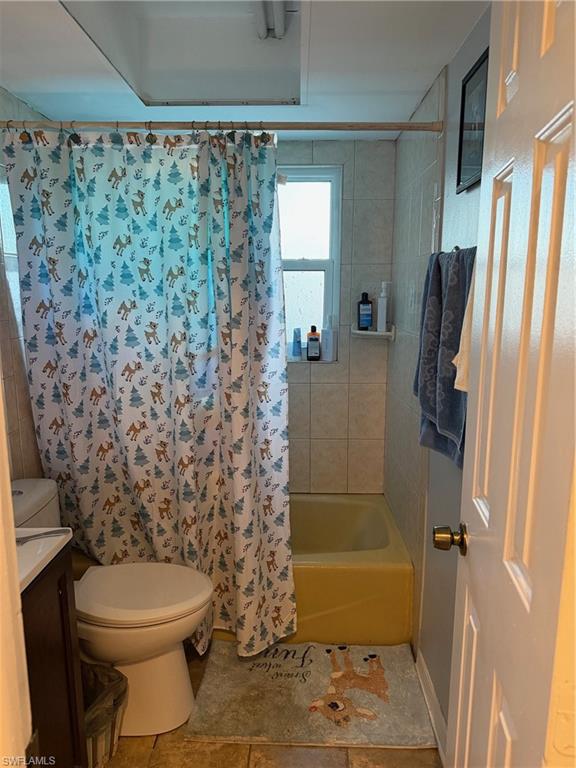 Full bathroom with vanity and shower / bath combination with curtain