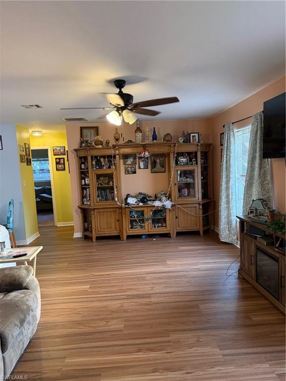 Living room with a ceiling fan and light wood-style floors