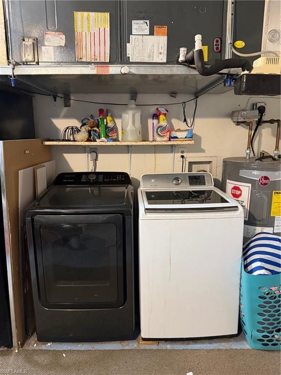 Laundry area featuring water heater, washer and dryer, and heating unit
