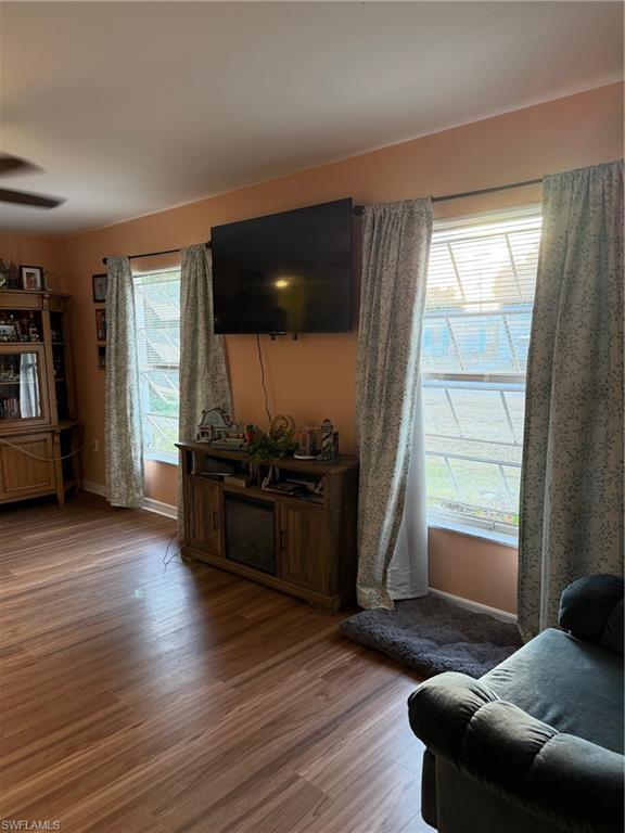 Living room featuring wood finished floors and ceiling fan