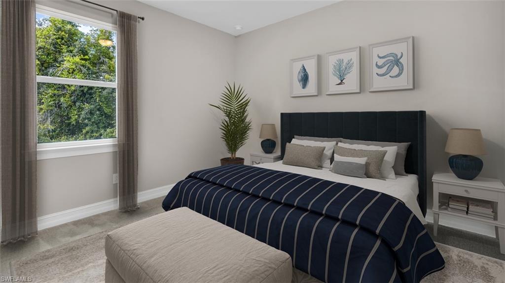This image is virtually staged. Bedroom with baseboards and carpet flooring