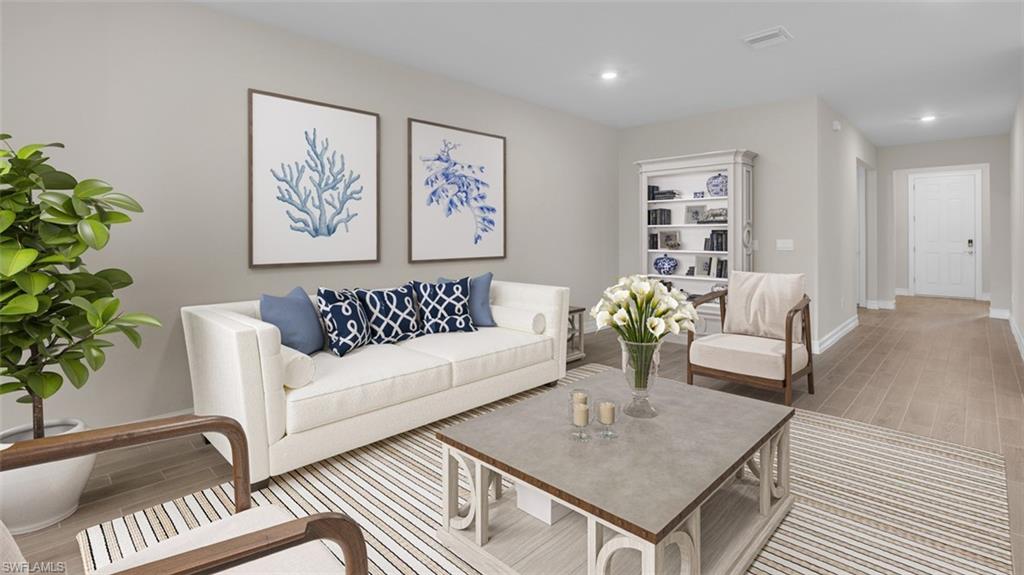 This image is virtually staged. Living area featuring wood tiled floors and recessed lighting