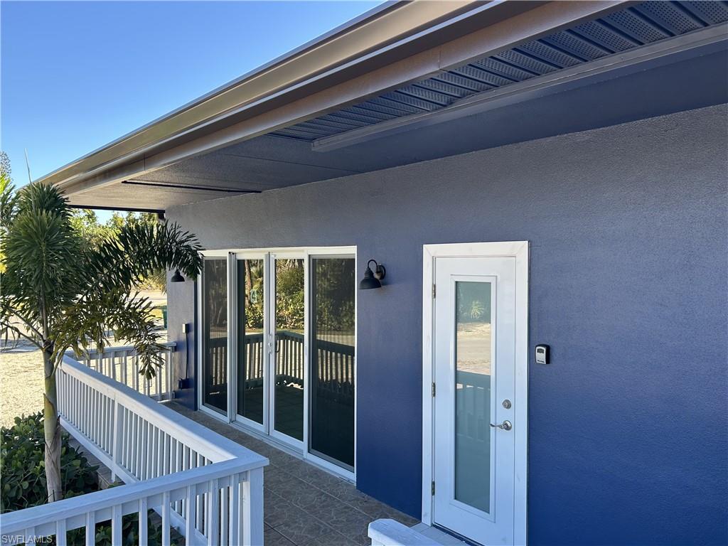Doorway to property with stucco siding