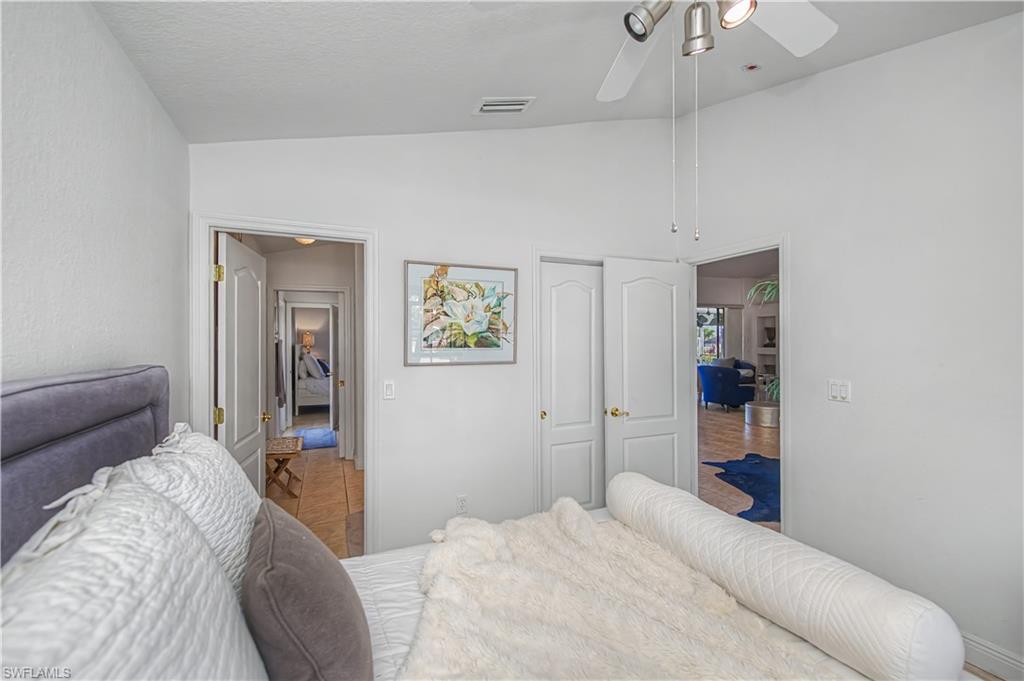 Bedroom with lofted ceiling and a ceiling fan