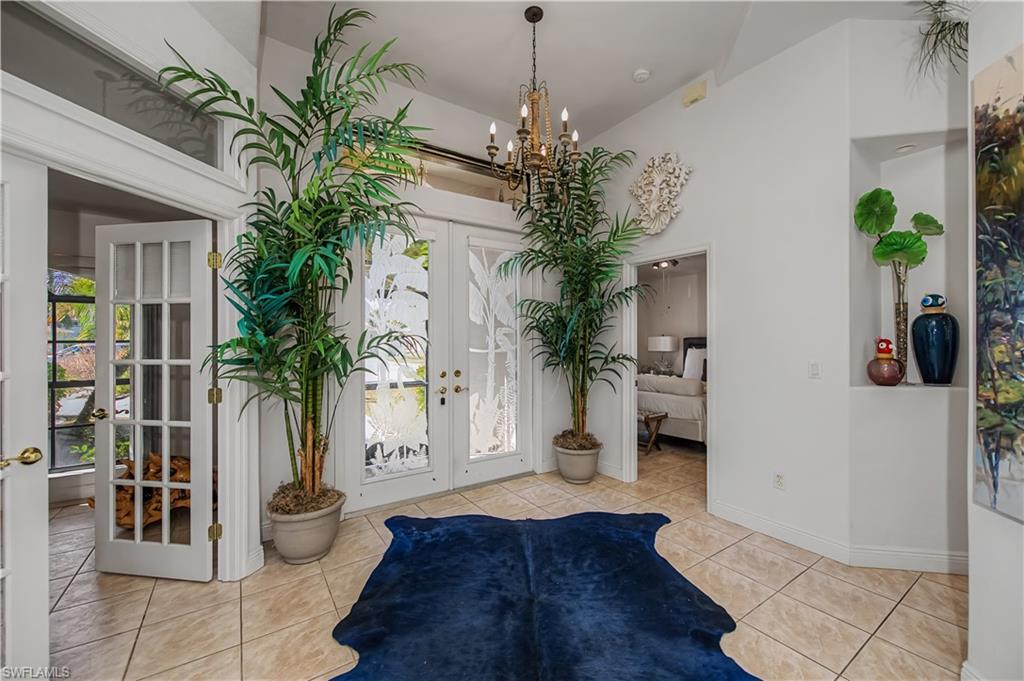 Foyer with french doors, a high ceiling, and a chandelier