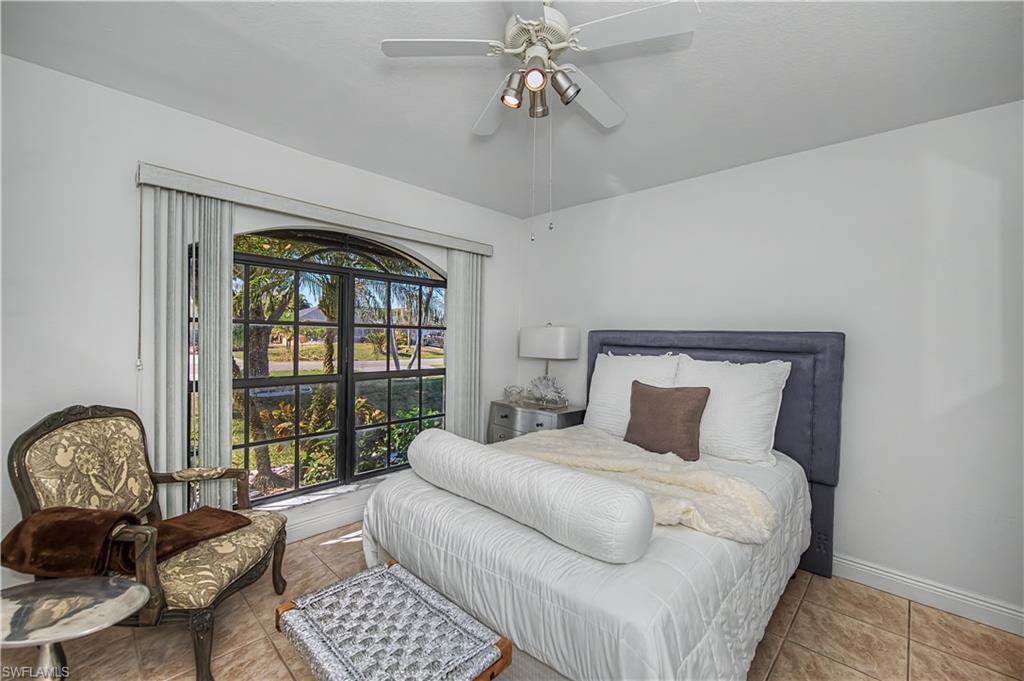 Bedroom with tile patterned floors and a ceiling fan