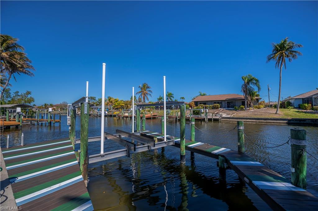 Dock with boat lift and a water view