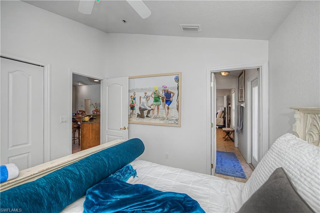 Bedroom with ceiling fan, lofted ceiling, and a closet