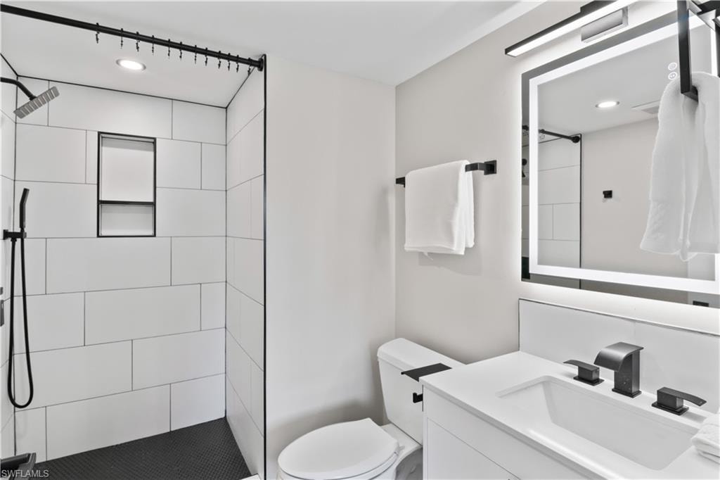 Modern guest bathroom with an all-new walk-in shower and a light-up mirror that adds a touch of sophistication and convenience.