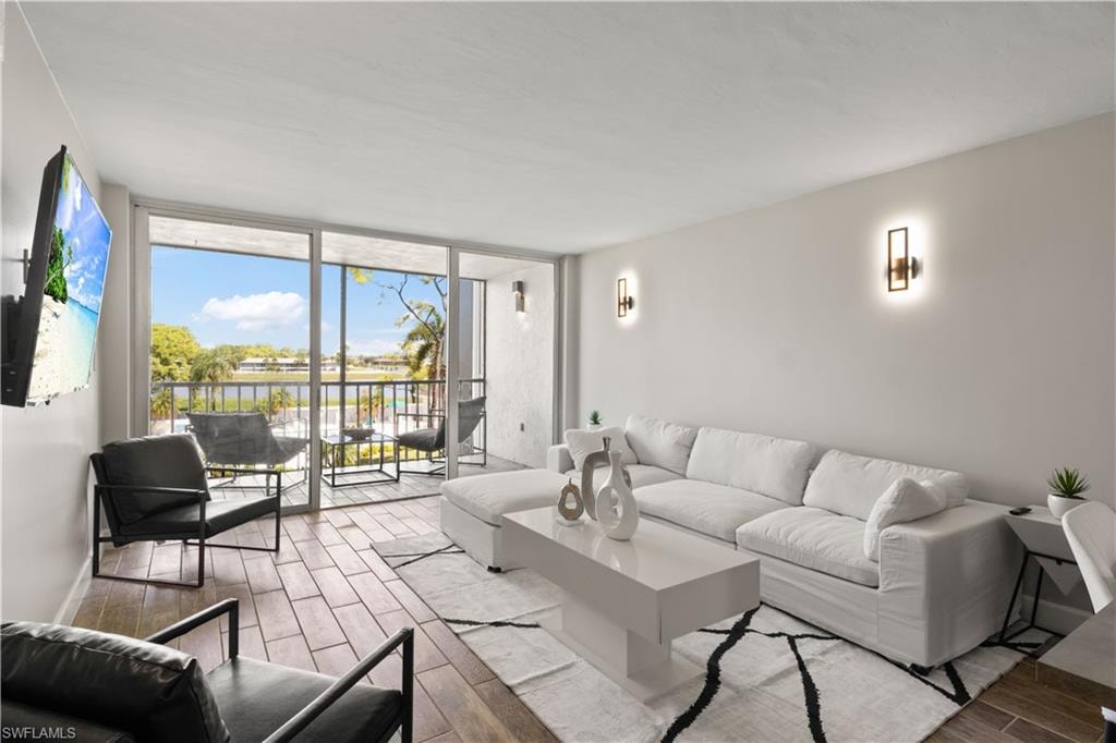 Bright living space with stylish new furnishings and peaceful lake vistas, creating a warm and welcoming atmosphere.