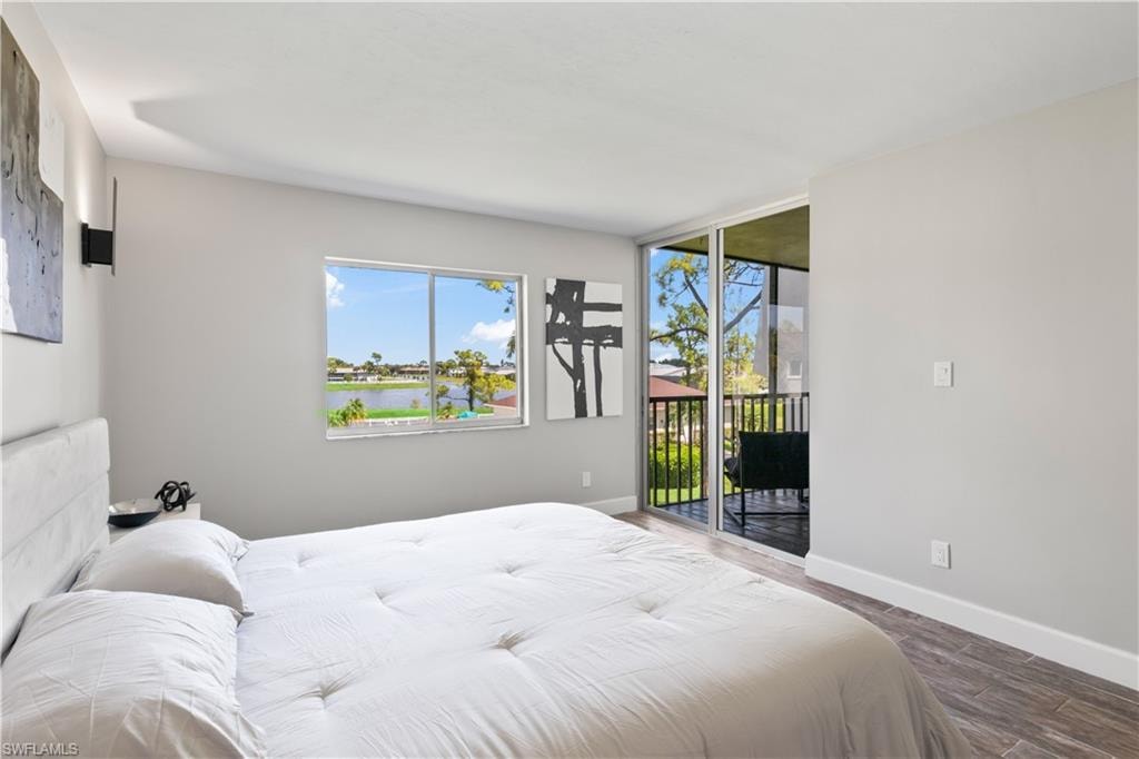 Spacious primary suite featuring brand new furniture and serene lake vistas.