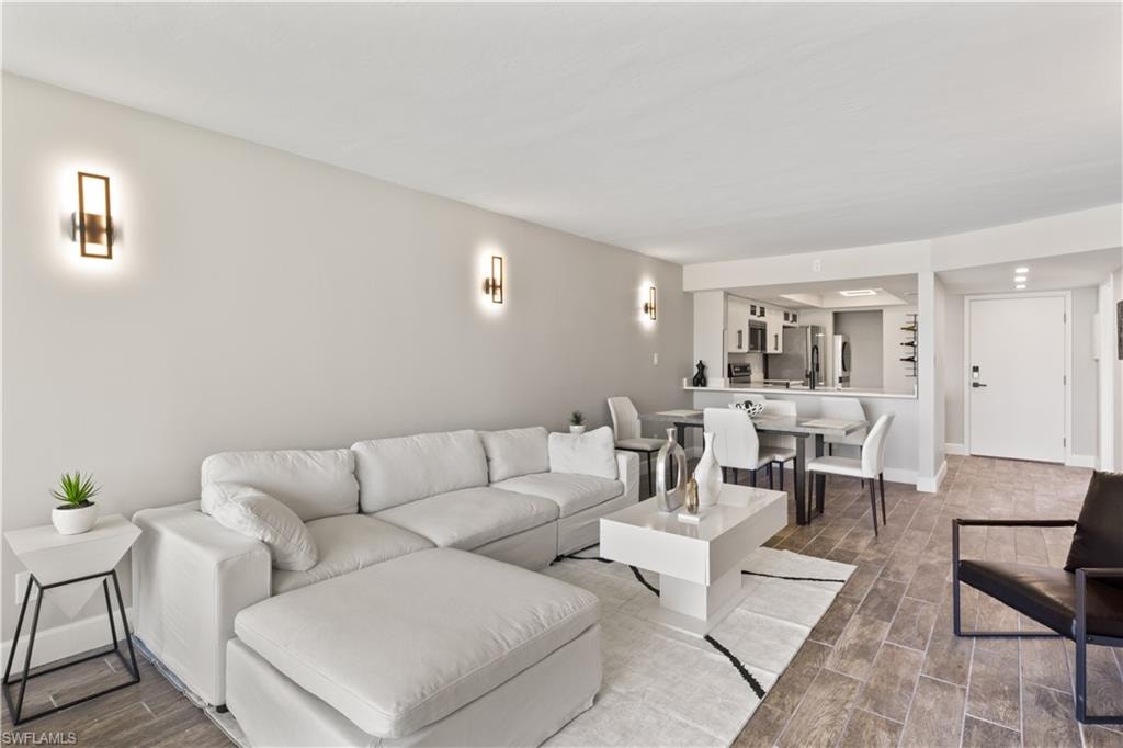 Inviting and cozy living space featuring fresh furnishings and a tranquil lake view, perfect for unwinding.