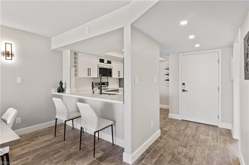 Welcome home to an open entryway leading into a modern kitchen with a breakfast bar.